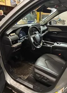 Detailed SUV interior with clean dashboard, steering wheel, and seats